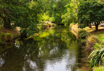Fototapeta na wymiar The Avon River running through Hagley Park in Christchurch in New Zealand. 