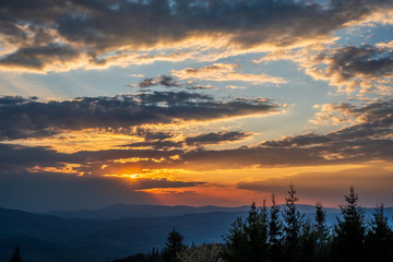 sunrise in the mountains with forest in the foreground with beautiful sky, czech republic beskydy Javorovy vrch