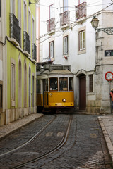 Naklejka na ściany i meble Cable car in a narrow street in Lisbon
