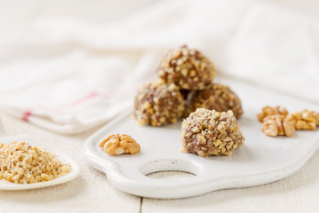 
chocolate cake on a plate. cocoa and nuts. white background and a towel. Rustic style in food photography