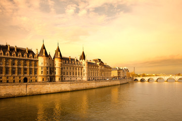 Fototapeta na wymiar The Conciergerie at Justice Palace and Pont Neuf Bridge over the Seine River, Ile de la Cite, Paris, France