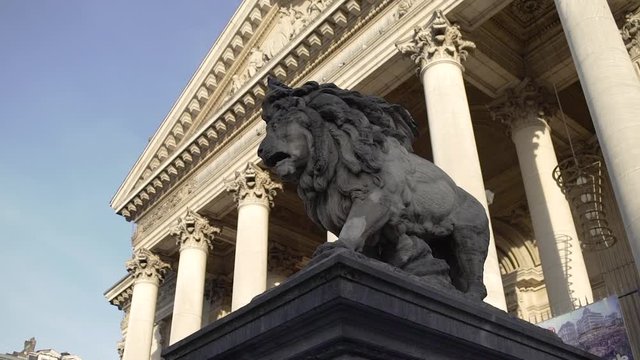 Lion statue and old building at la Bourse in Brussels Belgium in sunny evening weather