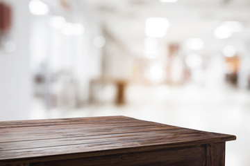 Empty wooden desk space and blurry background of restaurant vintage tone for product display montage.