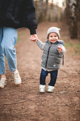 Fototapeta premium Mother and son walk in the spring Park