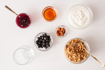Flat layout of white table with several bowls with healthy and tasty food