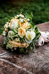 Beautiful wedding bouquet with wedding rings for bride. Colorful decoration for marriage and for married couple