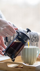 the process of brewing French press at home. French press on a wooden table
