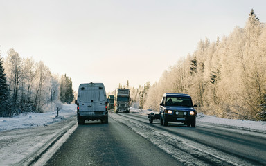 Mini van at Snowy forest Winter Road of Finland reflex