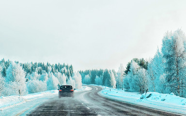 Car at winter road in Rovaniemi of Lapland in Finalnd reflex