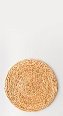 Wicker straw stand isolated on white background. Upright photo as flat lay, top view minimal social media template