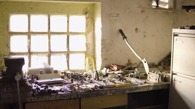 A table with DIY equipment and a bench vise in a workshop