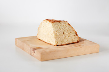 Slice of a homemade loaf of white bread on a wooden table