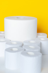 Rolls of toilet paper on color background