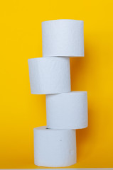 Rolls of toilet paper on color background
