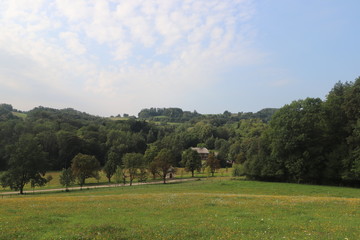 Green hill with patched cloudy skies in Leśnica, Kalwaria Zebrzydowska