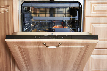 Open an empty dishwasher. Appliances in the kitchen