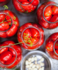 Pickling (canning) the tomatoes.