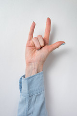 Rock on hand gesture. female hand showing two fingers. Vertical frame