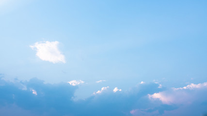 Beautiful clouds in blue sky background. Puffy and brilliant white clouds before sunset. Sky and...