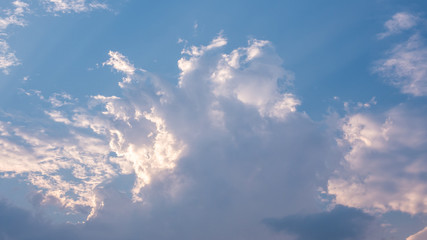 Beautiful clouds in blue sky background. Puffy and brilliant white clouds before sunset. Sky and clouds background