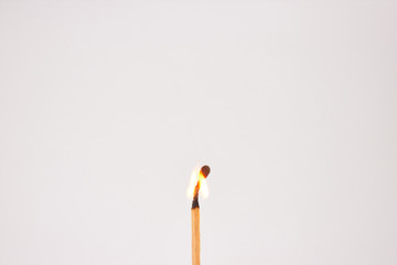 Burning match on white background