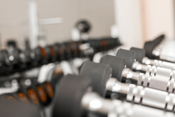 Dumbbells on stand in modern gym