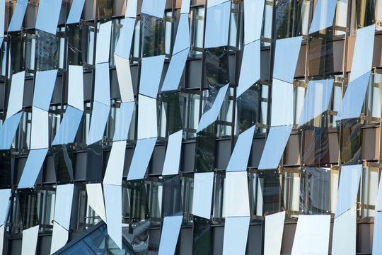 Futuristic glass wall. home. Modern building with irregular geometry