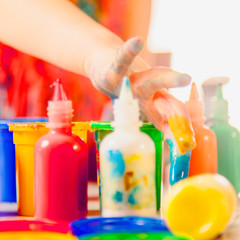 Young girl painting with fingers. Selective focus on fingers.