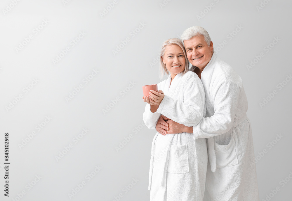 Canvas Prints Mature couple in bathrobes on grey background