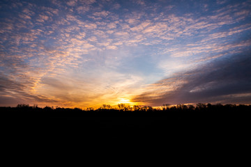 sunrise with beautiful sky and silhouette of forest