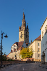 Lutheran Church with iconic bell tower in Sibiu on a beautiful sunny afternoon - 345103710