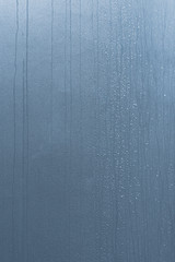 Light blue wall texture with rain drops on vertical composition