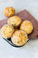 Savory spring herbs and cheese muffins in a bowl.