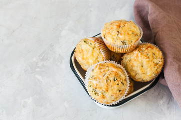 Savory spring herbs and cheese muffins in a bowl.