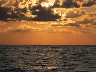 Epic sunset (dawn) on the sea. Waves are breaking on stones.