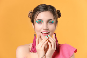 Young woman with beautiful manicure on color background