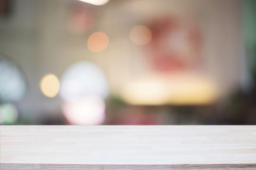 Desk space and blurry background of restaurant for product display montage.