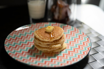 Dessert sweet carb pancake. Multi layer pancake with butter and sweet honey. Vintage pastel plate serve for after lunch break