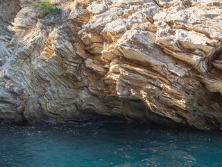 View of the coast from the sea. Amazing color of water, Bright sunny summer day.