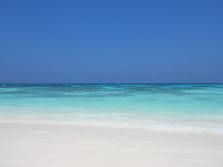 Blue sky and sea with white sand