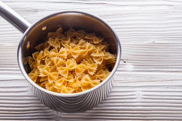traditional italian pasta in a metal pan on a wooden background