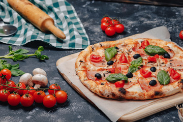 delicious Neapolitan pizza on board with cherry tomatoes, free space for text