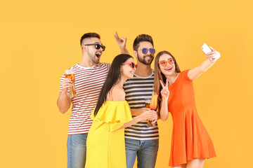 Happy young people taking selfie on color background