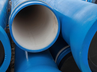 Stack of new blue pipes (tubes)