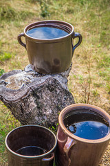 Clay pots with rainwater in a garden