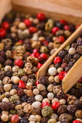 mix of peppercorns on white acrylic background