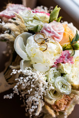 Wedding rings at the wedding bouquet