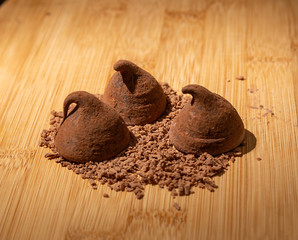 Chocolate truffles with grated chocolate on the table.