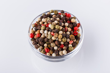 mix of peppercorns on white acrylic background
