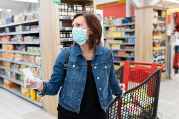 caucasian woman with medical mask shopping in supermarket